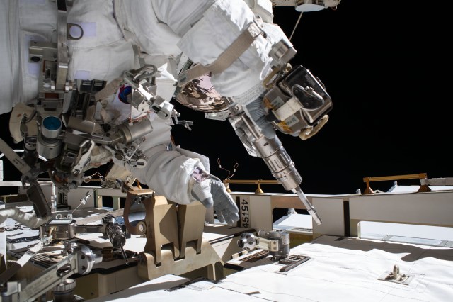 NASA astronaut and Expedition 63 Flight Engineer Bob Behnken works during a six-hour and one-minute spacewalk to swap an aging nickel-hydrogen battery for a new lithium-ion battery on the International Space Station's Starboard-6 truss structure. Behnken is pictured holding a pistol grip tool he used to remove and attach bolts that hold the batteries in place.