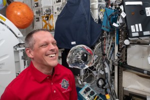 iss068e005874 (Oct. 1, 2022) --- NASA astronaut and Expedition 68 Flight Engineer Bob Hines has fun with fluid physics as he observes the behavior of a free-flying water bubble inside the International Space Station's Kibo laboratory module.
