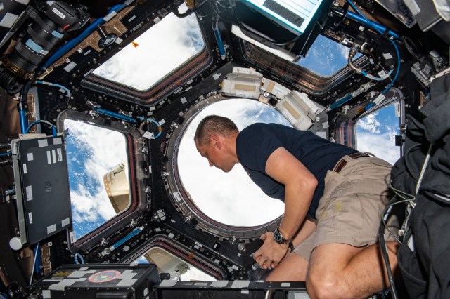 iss068e011296_alt (Oct. 2, 2022) --- NASA astronaut and Expedition 68 Flight Engineer Bob Hines is pictured inside the cupola, the International Space Station's "window to the world," looking at the Earth below while orbiting 260 miles above the Atlantic Ocean.
