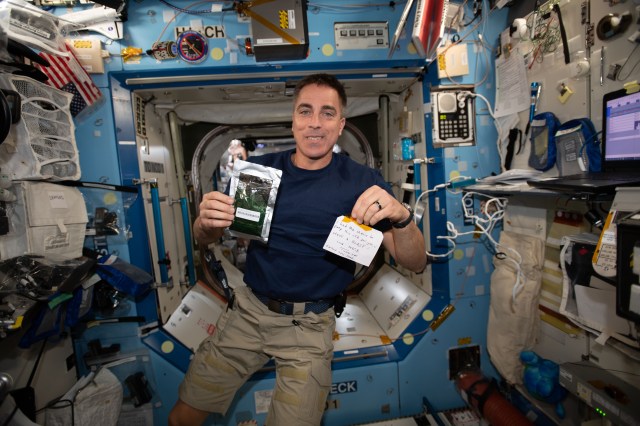 iss062e151565 (April 16, 2020) --- NASA astronaut Chris Cassidy holds a Parmigiana di Melanzane meal packet given to him by European Space Agency (ESA) astronaut Luca Parmitano. Parmitano left the International Space Station on February 6, 2020 completing the Expedition 60-61 mission. Cassidy arrived at the station two months later to begin the Expedition 63 mission. Cassidy and Parmitano were Expedition 36 crew mates during 2013. The note Cassidy is holding reads... "I had the chance to prep this CTB for you. :-) HAVE A BLAST! – Luca 347/19 – I HOPE YOU ENJOY THE FOOD…” CTB is an acronym for Cold Transfer Bag. 347/19 stands for mission date Dec. 13, 2019.