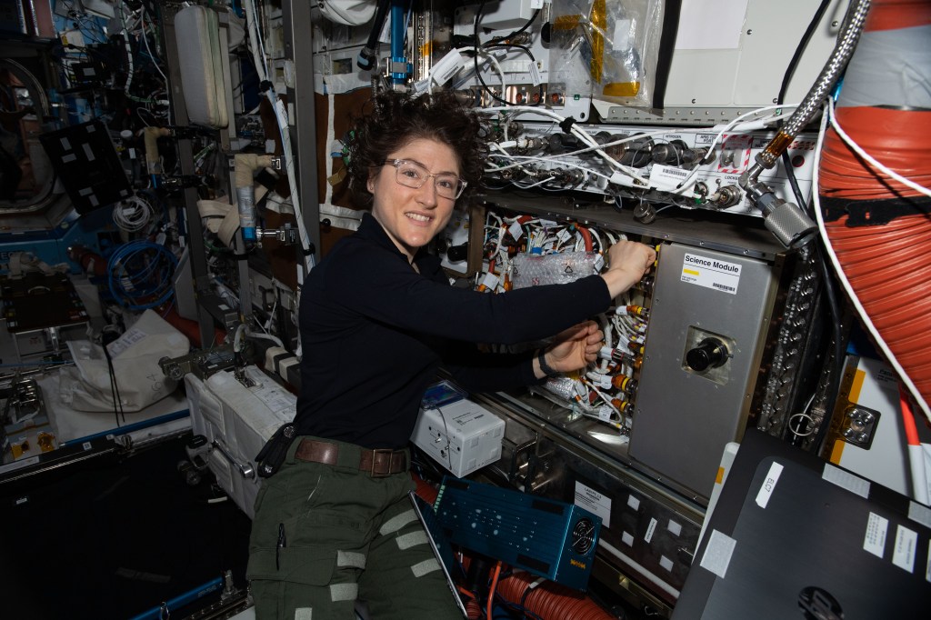 NASA astronaut and Expedition 61 Flight Engineer Christina Koch works on the Cold Atom Lab (CAL) swapping and cleaning hardware inside the quantum research device. The CAL enables research into the quantum effects of gases chilled to nearly absolute zero, which is colder than the average temperature of the universe.
