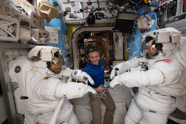 Canadian Space Agency astronaut David Saint-Jacques assists NASA astronauts Christina Koch (left) and Nick Hague as they verify their U.S. spacesuits are sized correctly and fit properly ahead of a set of upcoming spacewalks.