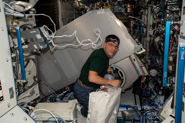 iss068e020375 (Nov. 1, 2022) --- NASA astronaut and Expedition 68 Flight Engineer Frank Rubio cleans fans. filters, and components inside the Microgravity Science Glovebox (MSG) after rotating it down from its rack slot in the U.S. Destiny laboratory module. The MSG hosts numerous space science experiments from physics to biology aboard the International Space Station. Credit: Josh Cassada/NASA