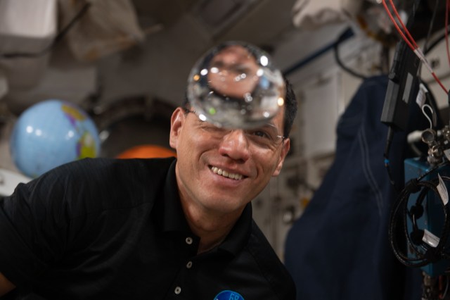 iss068e006386 (Oct. 1, 2022) --- NASA astronaut and Expedition 68 Flight Engineer Frank Rubio has fun with fluid physics as he observes the behavior of a free-flying water bubble inside the International Space Station's Kibo laboratory module.