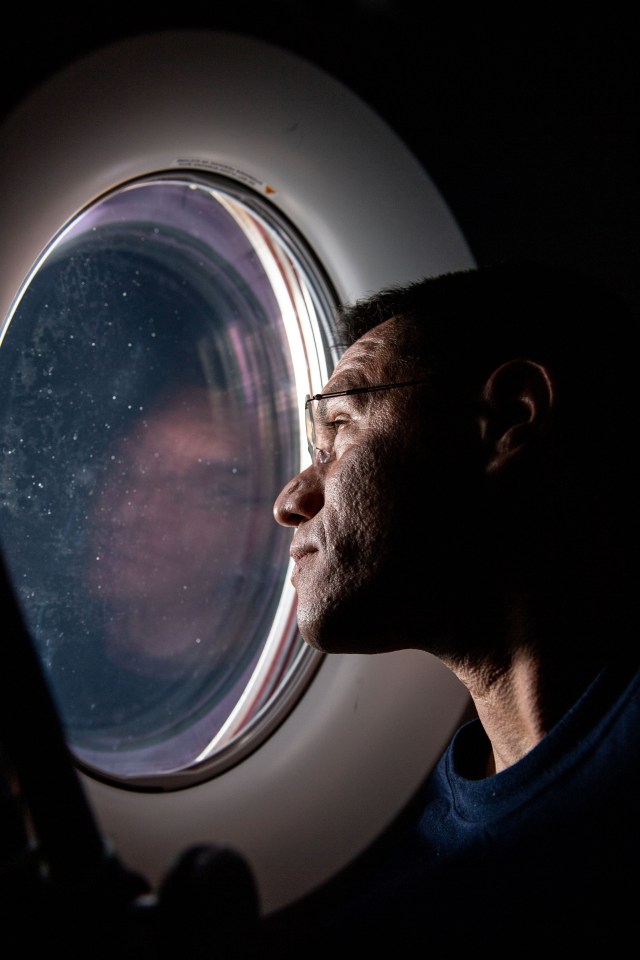 iss068e012594 (Oct. 6, 2022) --- NASA astronaut Frank Rubio peers out of a window aboard the SpaceX Dragon Freedom spacecraft docked to the International Space Station. Rubio was observing the SpaceX Dragon Endurance spacecraft, carrying four SpaceX Crew-5 crew members, approach the orbital lab for a docking to the Harmony module's forward port.