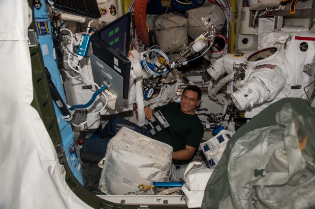 iss068e020555 (Nov. 2, 2022) --- NASA astronaut and Expedition 68 Flight Engineer Frank Rubio scrubs cooling loops inside Extravehicular Mobility Units (EMUs), or spacesuits, inside the International Space Station's Quest airlock.