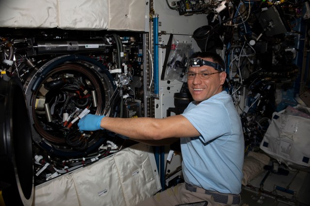 iss068e043130 (Jan. 30, 2023) --- NASA astronaut and Expedition 68 Flight Engineer Frank Rubio replaces experiment samples and research hardware inside the International Space Station's Combustion Integrated Rack for a study exploring how fires burn in weightlessness to improve fire safety techniques in space.