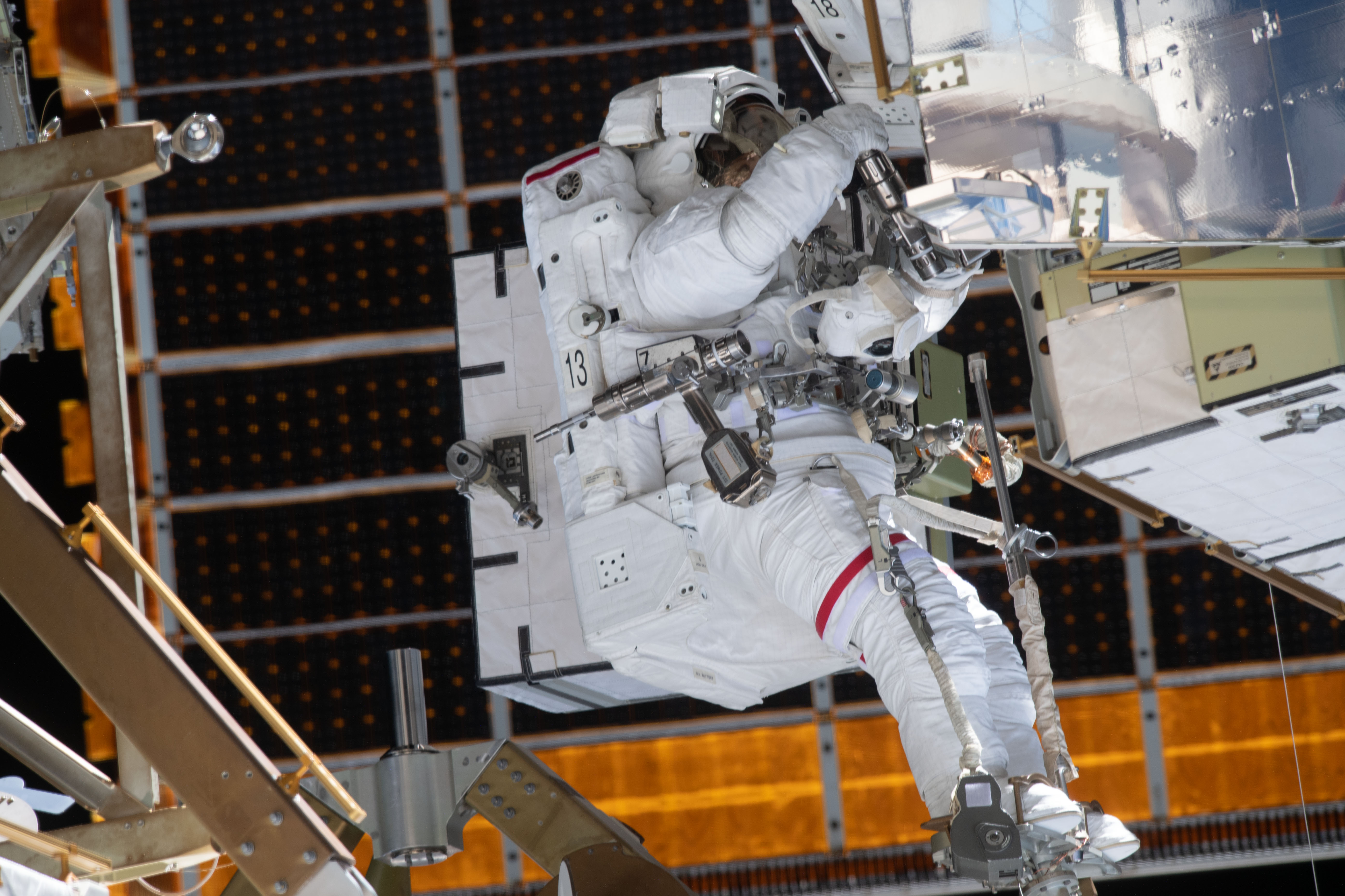 NASA astronaut Jessica Meir is outfitted with pistol grip tools and attached to an articulating portable foot restraint during a spacewalk to finalize upgrading power systems on the International Space Station's Port-6 truss structure.