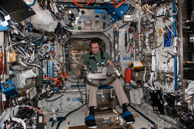 iss068e054121 (Feb. 14, 2023) --- NASA astronaut and Expedition 68 Flight Engineer Josh Cassada is seated in a specialized chair in the International Space Station's Columbus laboratory module for a human research experiment. The study investigates how astronauts regulate their grip force and move their arms when manipulating objects in microgravity in response to pre-programmed stimuli as a computer and video cameras record the responses.