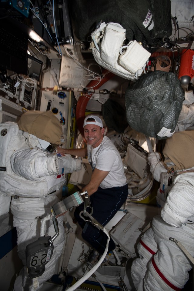 iss068e024795 (Nov. 26, 2022) --- NASA astronaut and Expedition 68 Flight Engineer Josh Cassada works on Extravehicular Mobility Units (EMUs), or spacesuits, inside the International Space Station's Quest airlock.
