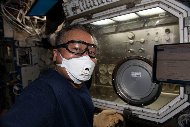 iss068e019720 (Oct. 24, 2022) --- Expedition 68 Flight Engineer Koichi Wakata of the Japan Aerospace Exploration Agency (JAXA) works on the Microgravity Science Glovebox, which hosts numerous space science experiments from physics to biology, and cleans its fans. filters, and components.