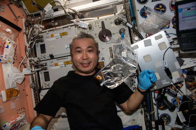 iss068e038130 (Jan. 6, 2023) --- Expedition 68 Flight Engineer Koichi Wakata of the Japan Aerospace Exploration Agency (JAXA) collects water samples from the International Space Station's potable water dispenser for analysis back on Earth.