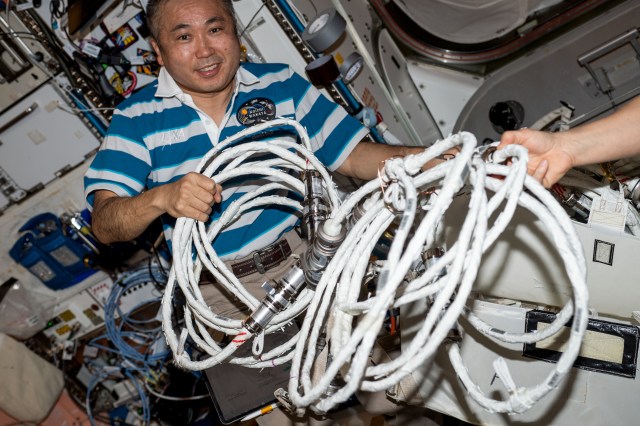 iss068e040899 (Jan. 19, 2023) --- Expedition 68 Flight Engineer Koichi Wakata of the Japan Aerospace Exploration Agency (JAXA) configures spacewalking hardware inside the International Space Station's Quest airlock.