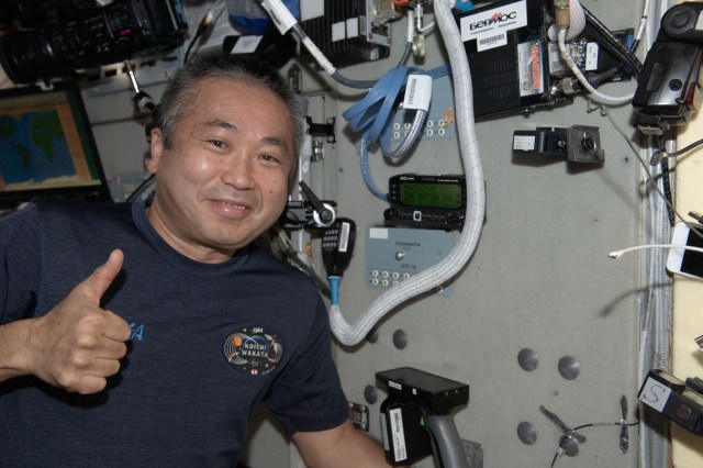 iss068e018996 (Oct. 24, 2022) --- Expedition 68 Flight Engineer Koichi Wakata of the Japan Aerospace Exploration Agency (JAXA) gives a "thumbs up" sign after powering on the Zvezda service module's ham radio aboard the International Space Station. Credit: JAXA/Koichi Wakata