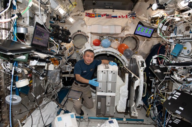iss068e033422 (Dec. 27, 2022) --- Expedition 68 Flight Engineer Koichi Wakata of the Japan Aerospace Exploration Agency (JAXA) installs the NanoRacks CubeSat Deployer inside the Kibo laboratory module's airlock for placement outside of the International Space Station.