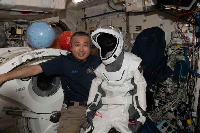 iss068e058259 (Feb. 26, 2023) --- Expedition 68 Flight Engineer Koichi Wakata of JAXA (Japan Aerospace Exploration Agency) shows off his SpaceX spacesuit he wore aboard the Crew Dragon Endurance spaceship when he launched to the International Space Station on Oct. 5 from the Kennedy Space Center in Florida.