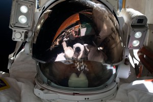 iss068e041204 (Jan. 20, 2022) --- Expedition 68 Flight Engineer Koichi Wakata of the Japan Aerospace Exploration Agency (JAXA) points the camera toward himself and takes a "space-selfie" during a seven-hour and 21-minute spacewalk to install a modification kit on the International Space Station's starboard truss structure preparing the orbital lab for its next roll-out solar array.