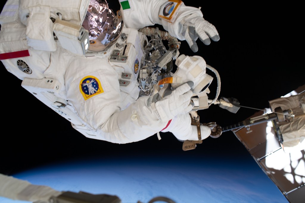 ESA (European Space Agency) astronaut Luca Parmitano rides on the end of the Canadarm2 robotic arm attached to an articulating portable foot restraint during the third spacewalk to upgrade the Alpha Magnetic Spectrometer's thermal pump system.