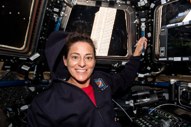 iss068e020608 (Nov. 3, 2022) --- NASA astronaut and Expedition 68 Flight Engineer Nicole Mann is pictured inside the seven window cupola, the International Space Station's "window to the world." Behind Mann and outside the cupola is one of the orbiting lab's main solar arrays. Credit: Koichi Wakata/Japan Aerospace Exploration Agency