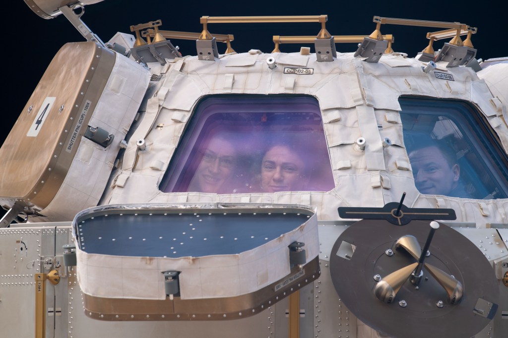 NASA astronauts (from left) Christina Koch, Jessica Meir and Andrew Morgan peer through the International Space Station's "window to the world," the cupola. The trio were on robotics duty monitoring the arrival and capture of the Cygnus space freighter from Northrop Grumman.