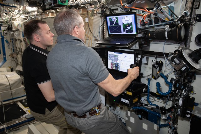 Astronauts David Saint-Jacques (foreground) and Nick Hague train to capture the SpaceX Dragon cargo craft on the robotics workstation inside the U.S. Destiny laboratory module.
