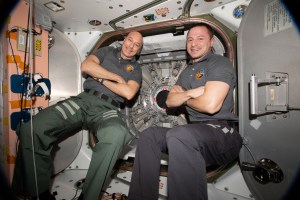 Astronauts (from left) Luca Parmitano of ESA (European Space Agency) and Andrew Morgan of NASA pose for a portrait in front the hatch that opens to the Cygnus space freighter from Northrop Grumman.
