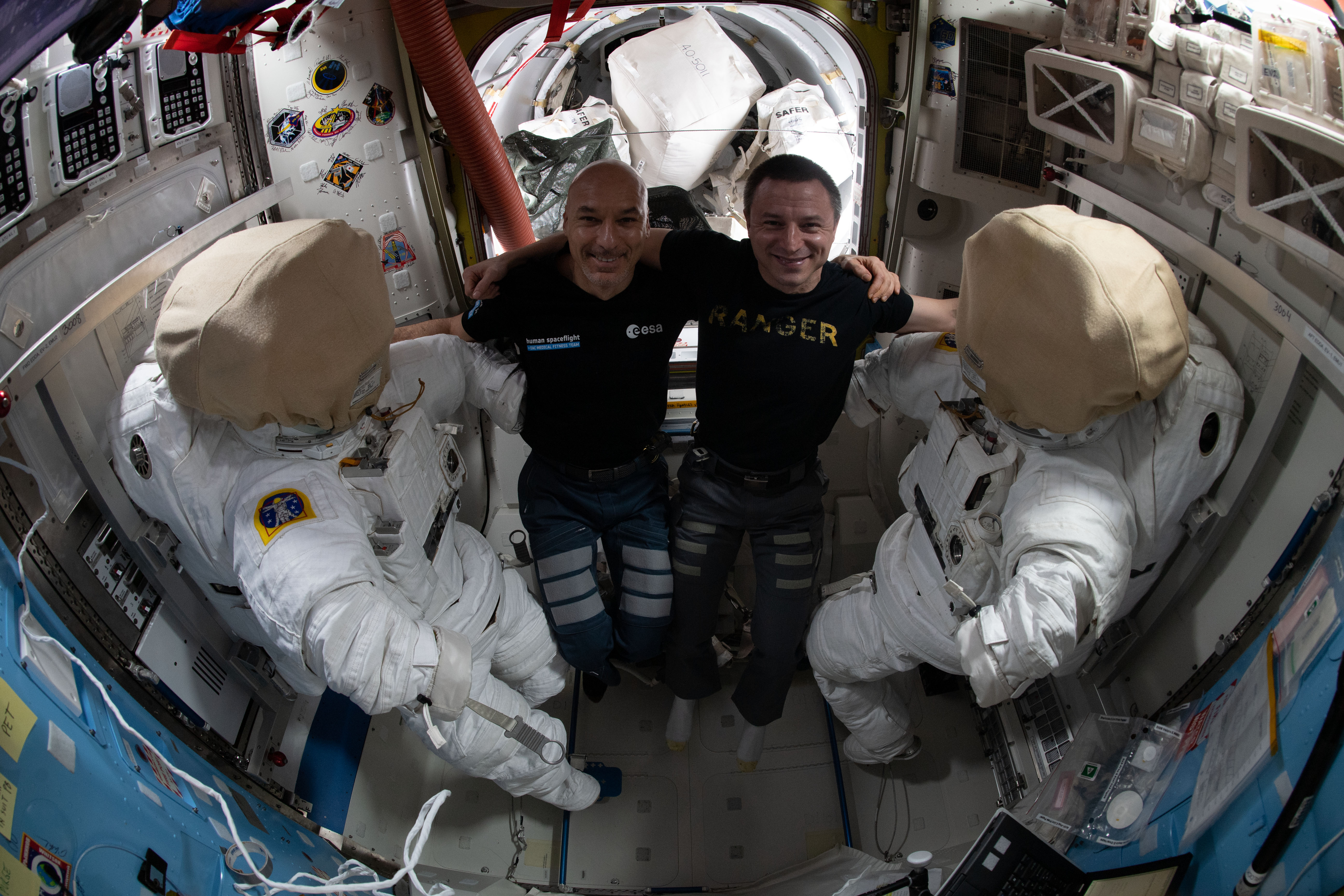 (From left) Commander Luca Parmitano of ESA (European Space Agency) and NASA astronaut Andrew Morgan work on U.S. spacesuits they will wear on a spacewalk scheduled for Jan. 25. The duo will finalize thermal repairs on the Alpha Magnetic Spectrometer, an astrophysics device searching for evidence of dark matter and antimatter on the International Space Station's Starboard-3 truss structure.