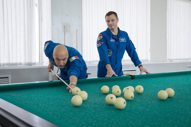 At their Cosmonaut Hotel crew quarters in Baikonur, Kazakhstan, Expedition 59 backup crew members Luca Parmitano of the European Space Agency (left) and Drew Morgan of NASA (right) take a moment from pre-launch training for a game of billiards March 7. Along with Alexander Skvortsov of Roscosmos, they are the backups to the prime crew members, Christina Koch of NASA, Alexey Ovchinin of Roscosmos and Nick Hague of NASA, who will launch March 14, U.S. time, on the Soyuz MS-12 spacecraft from the Baikonur Cosmodrome for a six-and-a-half month mission on the International Space Station.