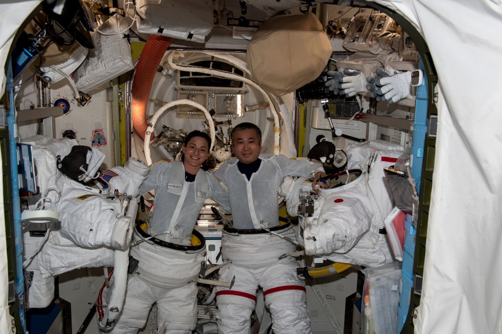 iss068e040060 (Jan. 12, 2023) --- Expedition 68 Flight Engineers Nicole Mann of NASA and Koichi Wakata of the Japan Aerospace Exploration Agency (JAXA) are pictured during a fit check of their Extravehicular Mobility Units (EMUs), or spacesuit, inside the Quest airlock ahead of a planned spacewalk to upgrade the International Space Station's power generation system.