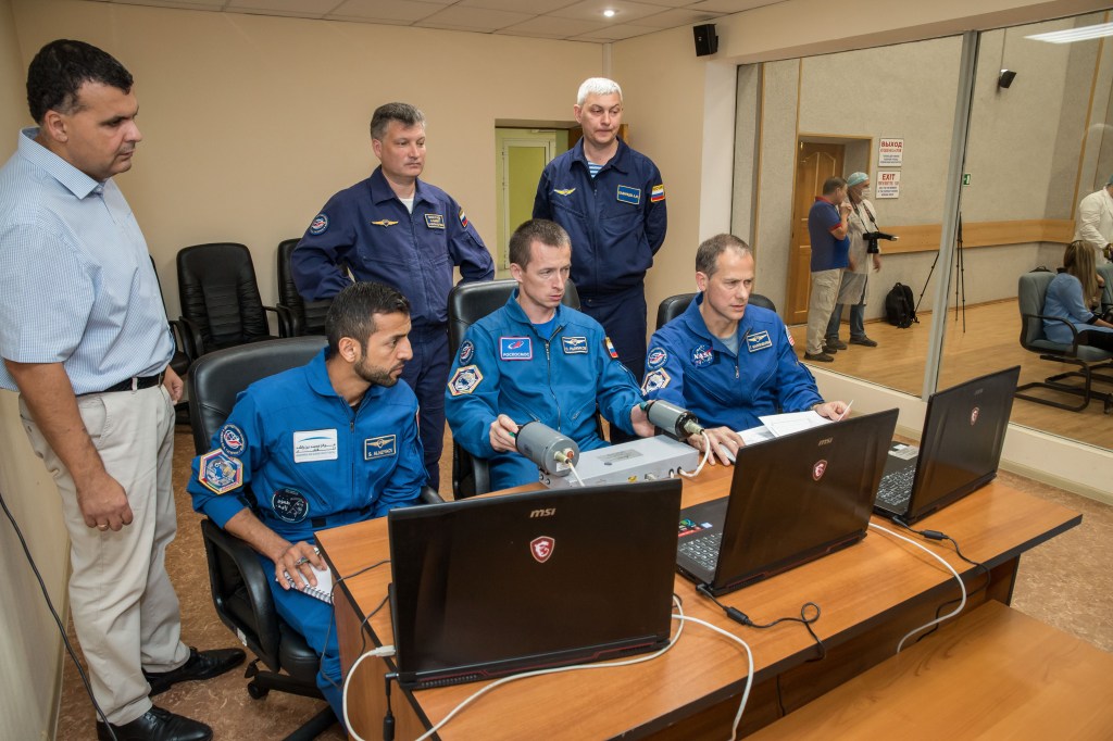 At the Cosmonaut Hotel crew quarters in Baikonur, Kazakhstan, the backups to the next crew to launch to the International Space Station practices rendezvous techniques Sept. 18 as part of pre-launch training. Backup spaceflight participant Sultan Al-Neyadi of the United Arab Emirates (left) and crewmates Sergey Ryzhikov of Roscosmos (center) and Tom Marshburn of NASA (right) will back up the prime crew, spaceflight participant Hazzaa ali Almansoori of the United Arab Emirates, Oleg Skripochka of Roscosmos and Jessica Meir of NASA, who are set to launch Sept. 25 from the Baikonur Cosmodrome in Kazakhstan on the Soyuz MS-15 spacecraft for a mission on the International Space Station.