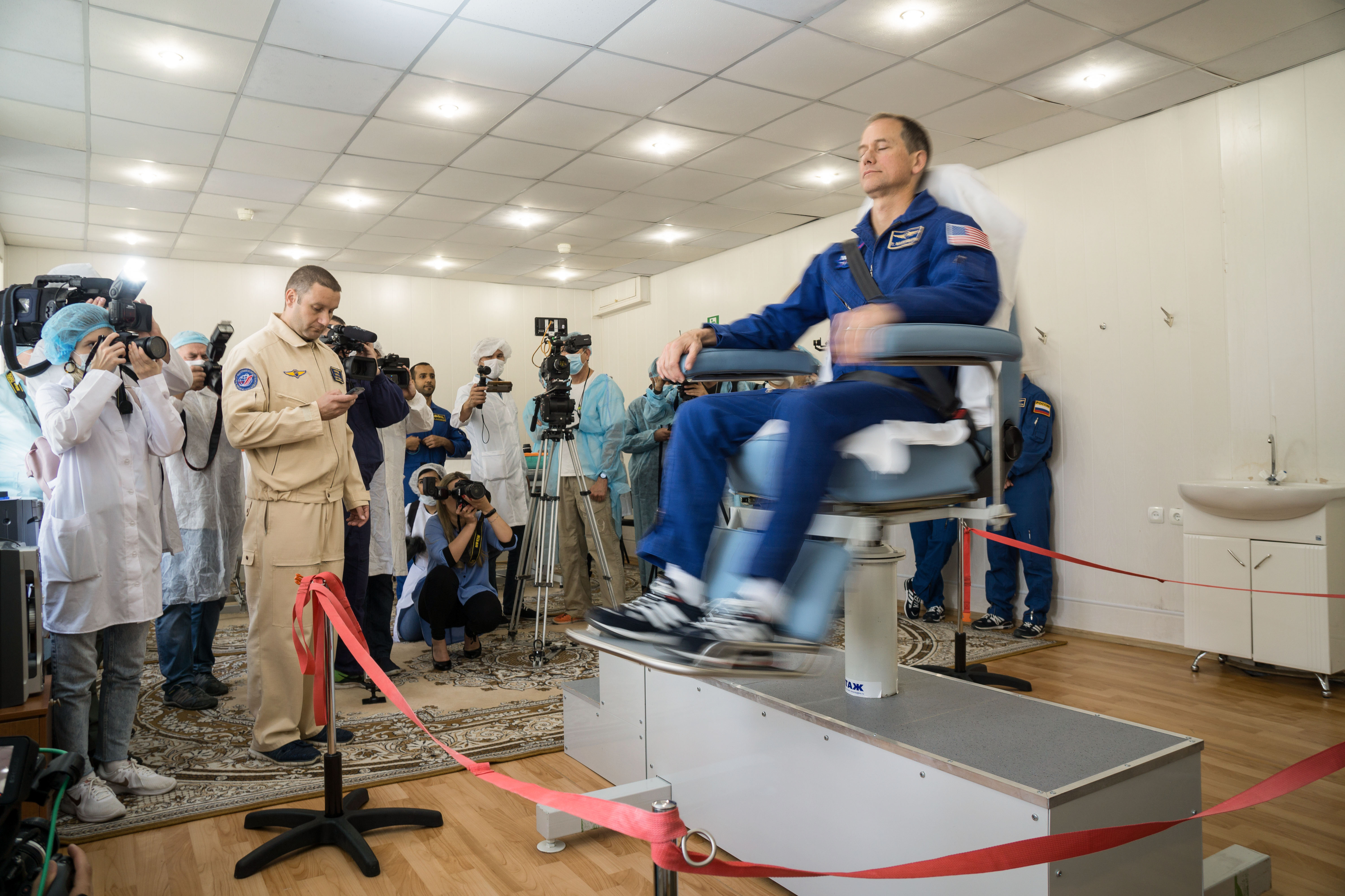At the Cosmonaut Hotel crew quarters in Baikonur, Kazakhstan, backup Expedition 61 crewmember Tom Marshburn of NASA takes a spin in a rotating chair Sept. 18 to test his vestibular system as part of pre-launch activities. He is one of the backups to the prime crew, spaceflight participant Hazzaa ali Almansoori of the United Arab Emirates and Expedition 61 crewmembers Oleg Skripochka of Roscosmos and Jessica Meir of NASA, who are set to launch Sept. 25 from the Baikonur Cosmodrome in Kazakhstan on the Soyuz MS-15 spacecraft for a mission on the International Space Station.