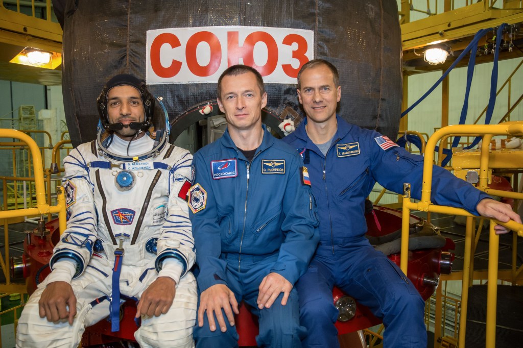 In the Integration Building at the Baikonur Cosmodrome in Kazakhstan, backup spaceflight participant Sultan Al-Neyadi of the United Arab Emirates (left) and backup Expedition 61 crewmates Sergey Ryzhikov of Roscosmos (center) and Tom Marshburn of NASA (right) pose for pictures Sept. 11 in front of the Soyuz MS-15 spacecraft. They are the backups to the prime crew, spaceflight participant Hazzaa Ali Almansoori of the United Arab Emirates and Expedition 61 crewmembers Oleg Skripochka of Roscosmos and Jessica Meir of NASA, who will launch Sept. 25 on the Soyuz MS-15 spacecraft from the Baikonur Cosmodrome for a mission on the International Space Station.