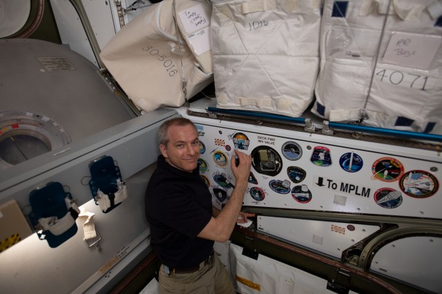 Canadian Space Agency astronaut David Saint-Jacques signs the inside of the vestibule between the SpaceX Dragon cargo craft and the Harmony module. The hatch to Dragon was later closed and the resupply ship detached from Harmony before it was released from the grips of the Canadarm2 robotic arm. Dragon spent nearly a month attached to the International Space Station.