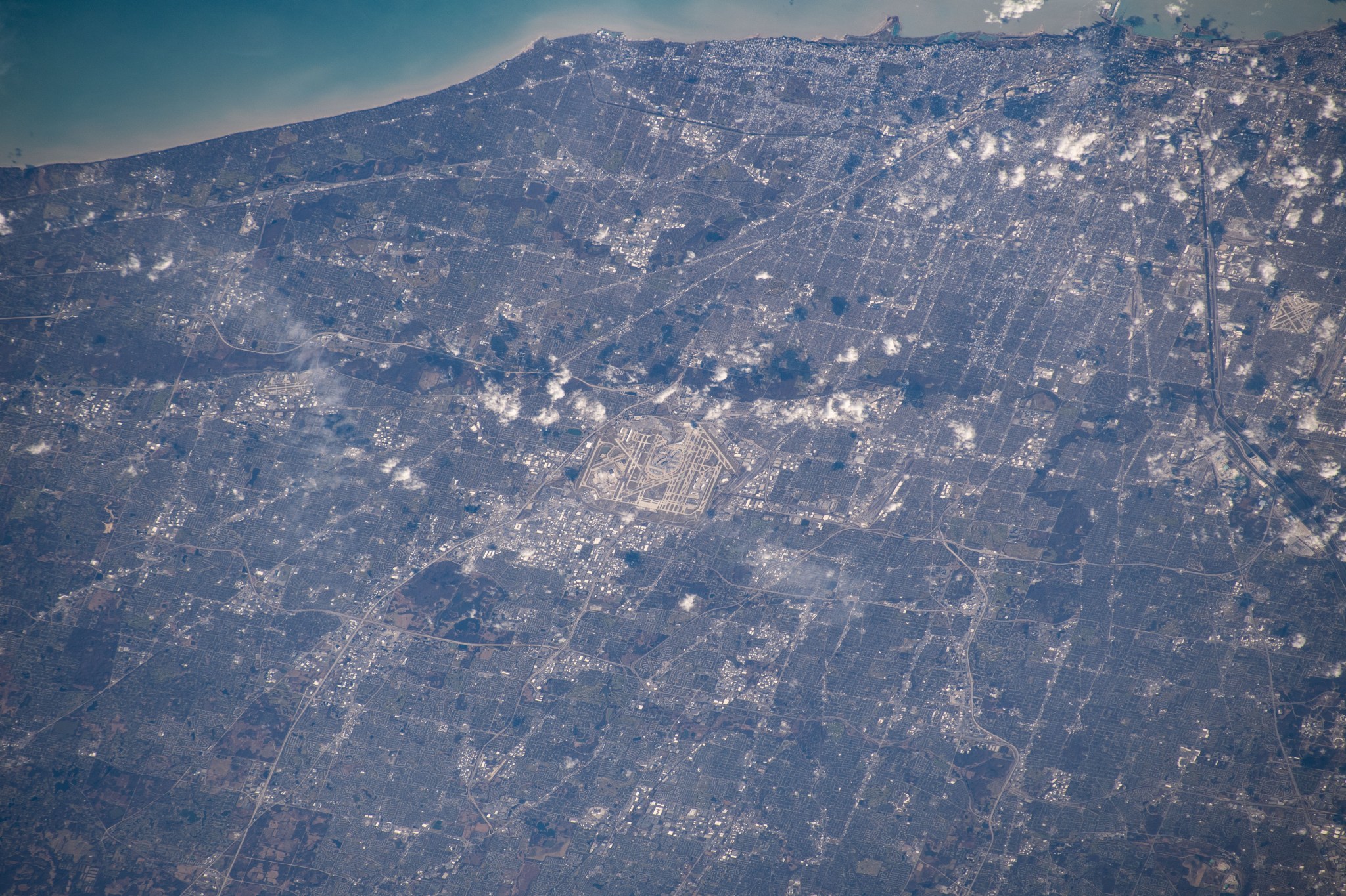 Chicago's O'Hare International Airport is centered in this photograph with the Windy City's downtown at the top right corner on the coast of Lake Michigan. The International Space Station was orbiting 259 miles above the state of Illinois when this picture was taken.