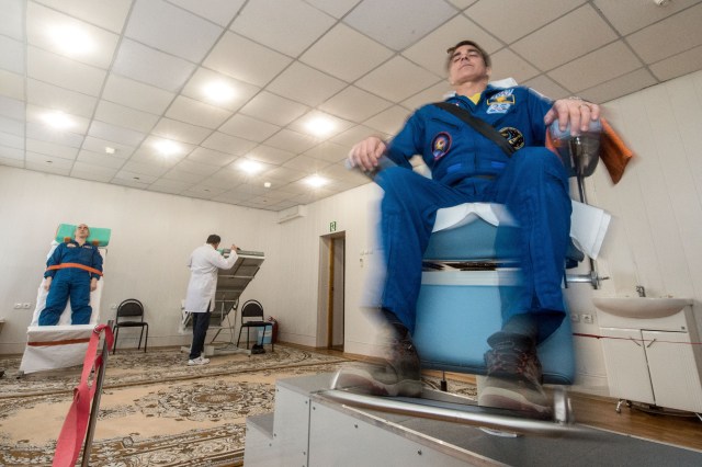 jsc2020e016967 (April 1, 2020) - At the Cosmonaut Hotel crew quarters in Baikonur, Kazakhstan, Expedition 63 crewmembers Chris Cassidy of NASA (right) and Anatoly Ivanishin of Roscosmos (left) take a spin April 1 to test their vestibular systems as part of pre-launch training. Cassidy, Ivanishin and Ivan Vagner of Roscosmos will launch April 9 on the Soyuz MS-16 spacecraft from the Baikonur Cosmodrome in Kazakhstan for a six-and-a-half month mission on the International Space Station.