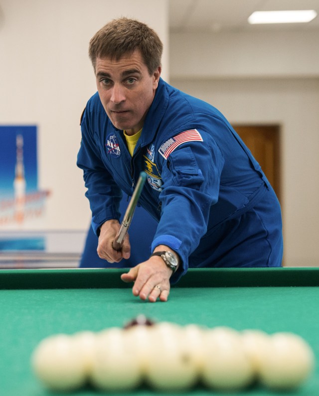 jsc2020e016963 (April 1, 2020) - At the Cosmonaut Hotel crew quarters in Baikonur, Kazakhstan, Expedition 63 crewmember Chris Cassidy of NASA plays a game of billiards April 1. Cassidy and Ivan Vagner and Anatoly Ivanishin of Roscosmos will launch April 9 on the Soyuz MS-16 spacecraft from the Baikonur Cosmodrome in Kazakhstan for a six-and-a-half month mission on the International Space Station.