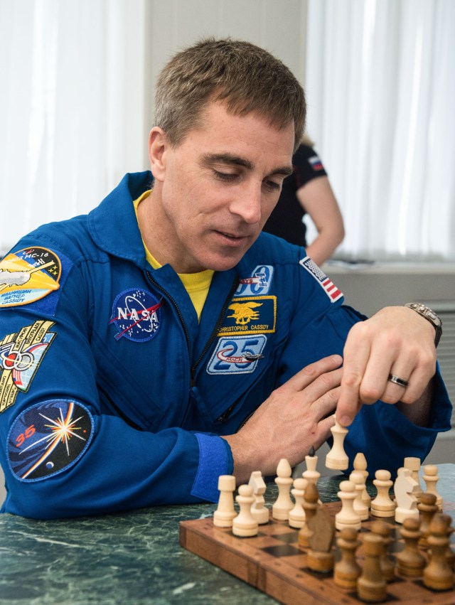 jsc2020e016961 (April 1, 2020) - At the Cosmonaut Hotel crew quarters in Baikonur, Kazakhstan, Expedition 63 crewmember Chris Cassidy of NASA plays a game of chess April 1. Cassidy and Ivan Vagner and Anatoly Ivanishin of Roscosmos will launch April 9 on the Soyuz MS-16 spacecraft from the Baikonur Cosmodrome in Kazakhstan for a six-and-a-half month mission on the International Space Station.