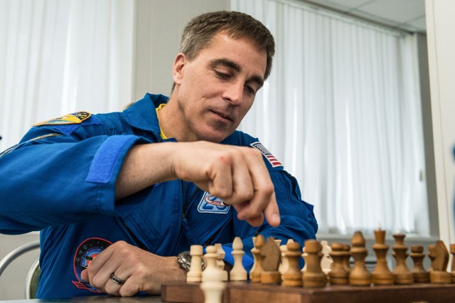 jsc2020e016962 (April 1, 2020) - At the Cosmonaut Hotel crew quarters in Baikonur, Kazakhstan, Expedition 63 crewmember Chris Cassidy of NASA plays a game of chess April 1. Cassidy and Ivan Vagner and Anatoly Ivanishin of Roscosmos will launch April 9 on the Soyuz MS-16 spacecraft from the Baikonur Cosmodrome in Kazakhstan for a six-and-a-half month mission on the International Space Station.