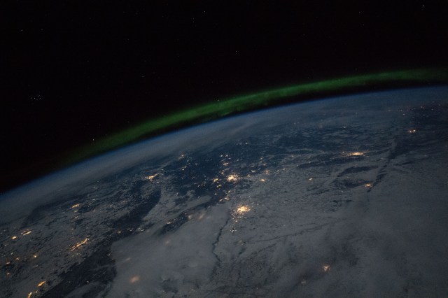 City lights and the aurora are pictured during a nighttime pass as the International Space Station orbited 256 miles above Russia and Kazakhstan.