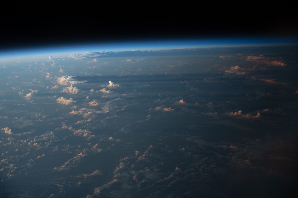 iss068e022267 (Nov. 13, 2022) --- Cloud shadows stretch across the Earth during an orbital sunset as the International Space Station soared 258 miles above the Atlantic coast of Suriname in South America.