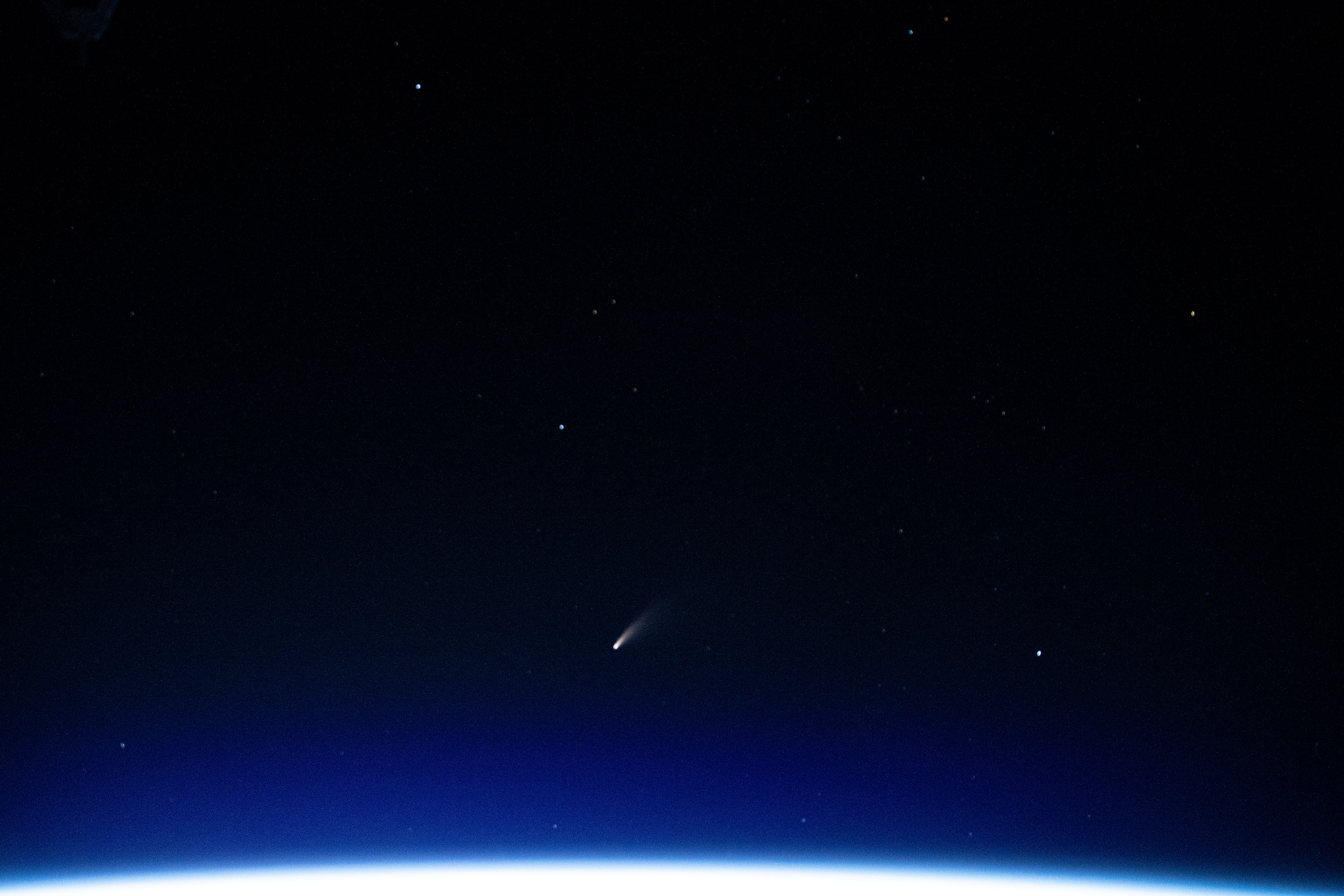 The tiny shooting star in the lower center of this image is Comet Neowise pictured from the International Space Station as it orbited above the Mediterranean Sea in between Tunisia and Italy.