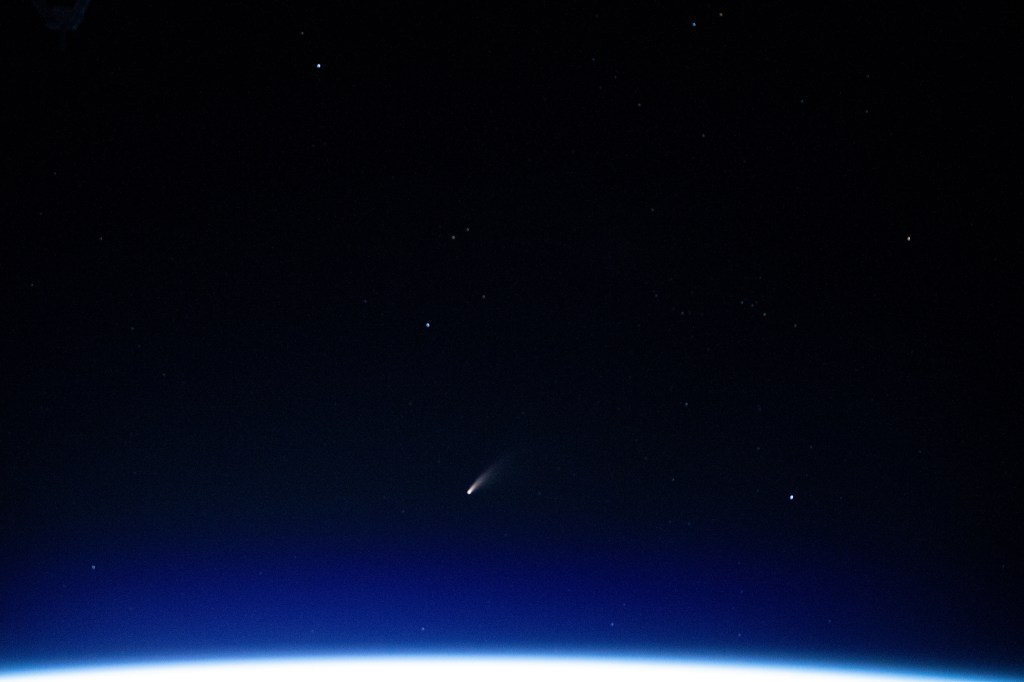 The tiny shooting star in the lower center of this image is Comet Neowise pictured from the International Space Station as it orbited above the Mediterranean Sea in between Tunisia and Italy.