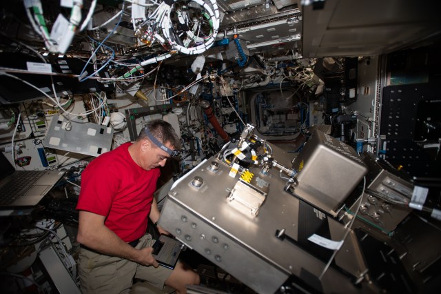 NASA astronaut and Expedition 63 Commander Chris Cassidy works on the Fluids Integrated Rack (FIR) replacing components in the research device that studies the behavior of fluids in microgravity. The FIR will help promote the design of advanced space-based fuel tanks and other complex fluid transfer systems.