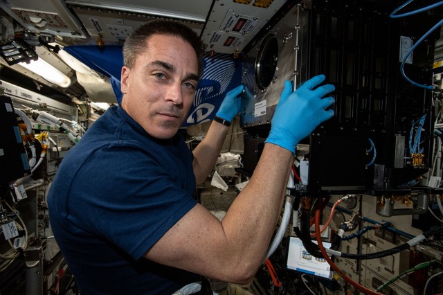 NASA astronaut and Expedition 63 Commander Chris Cassidy works on the Soft Matter Dynamics experiment that explores how planetary bodies might affect the density and dynamics of different materials.