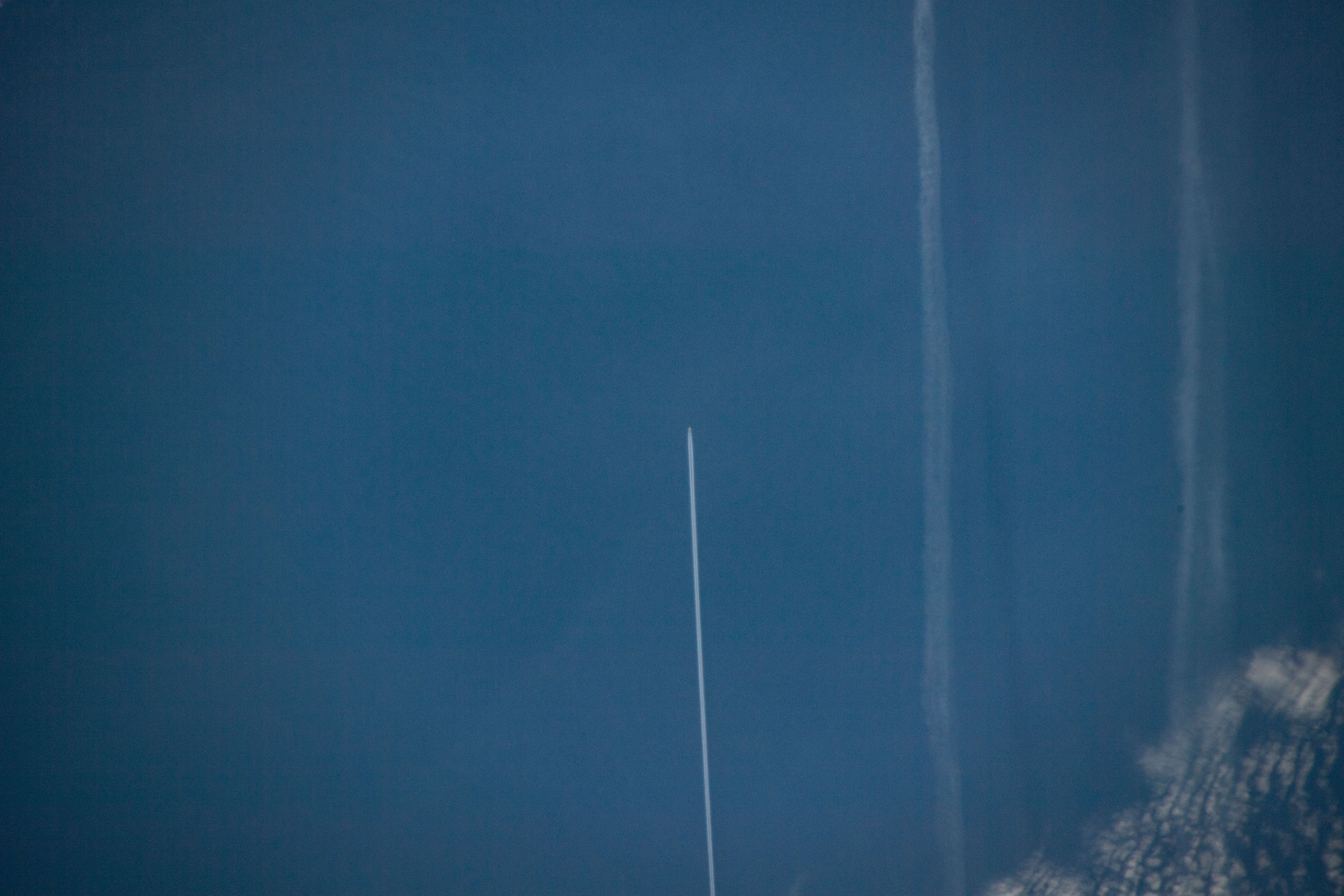 258 miles above the North Atlantic Ocean an Expedition 59 crewmember photographed the contrail of an aircraft flying below as the International Space Station approached the coast of Ireland.