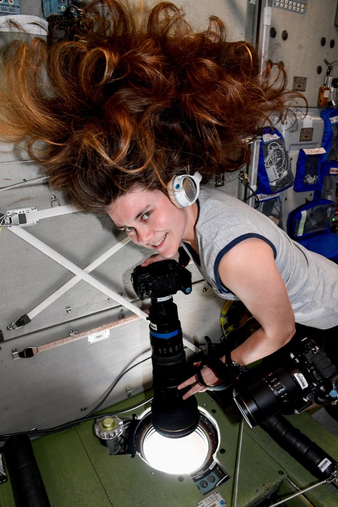 iss068e042077 (Jan. 22, 2023) --- Roscosmos cosmonaut and Expedition 68 Flight Engineer Anna Kikina points a camera outside a window inside the International Space Station's Zvezda service module and photographs landmarks for an Earth observation study.