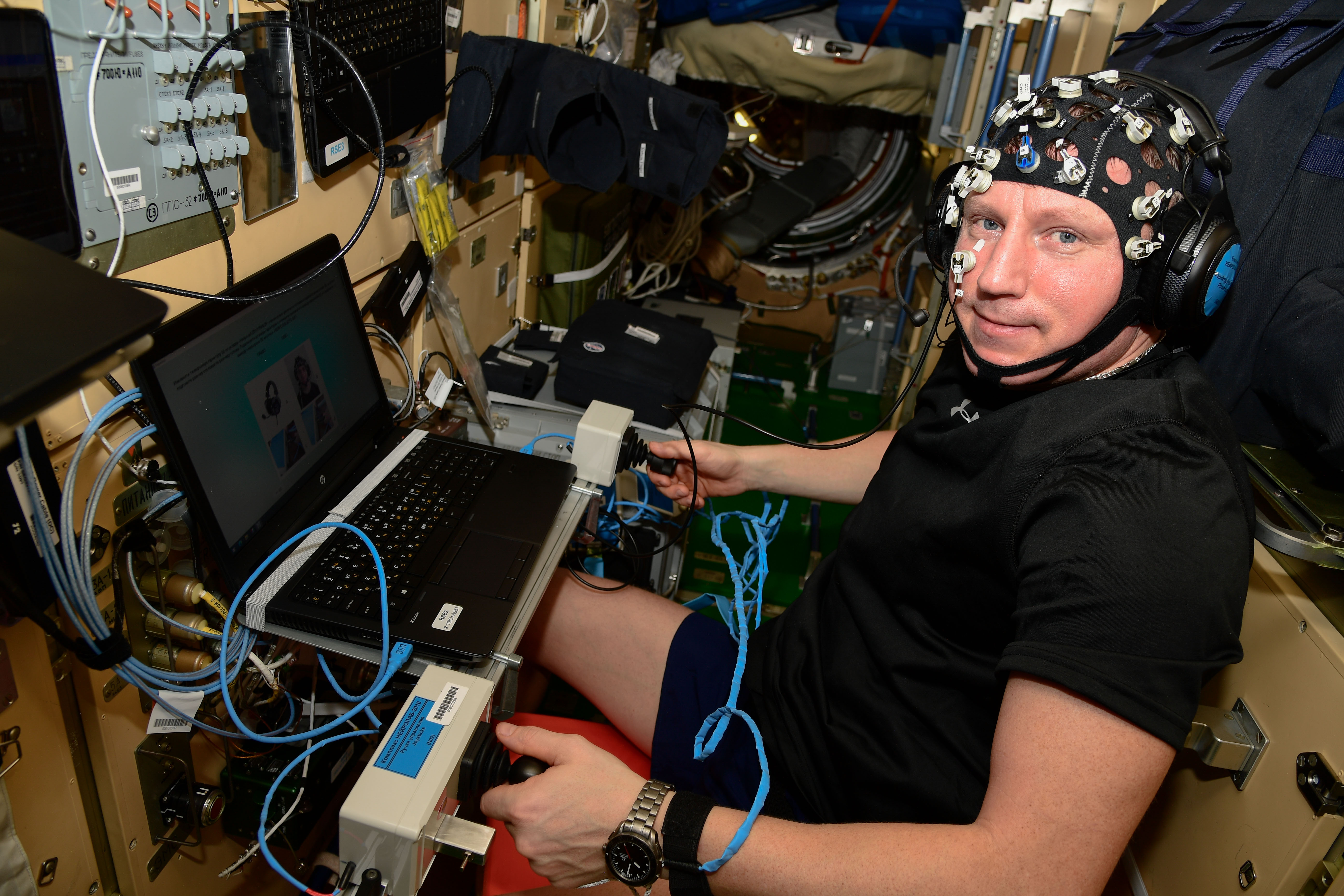 iss068e040292 (Jan. 16, 2023) --- Roscosmos cosmonaut and Expedition 68 Commander Sergey Prokopyev wears a head cap with sensors measuring his performance while practicing on a computer potential spacecraft and robotic piloting techniques a crew member might use during future planetary missions.