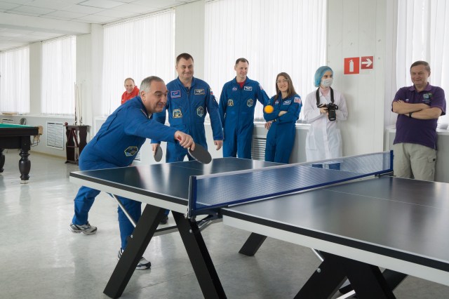 At their Cosmonaut Hotel crew quarters in Baikonur, Kazakhstan, Expedition 59 backup crew member Alexander Skvortsov of Roscosmos (left) and prime crew member Alexey Ovchinin of Roscosmos (right) take a break from pre-launch training March 7 for a game of ping-pong. Looking on against the wall are prime crewmembers Nick Hague and Christina Koch of NASA. Ovchinin, Hague and Koch will launch March 14, U.S. time, on the Soyuz MS-12 spacecraft from the Baikonur Cosmodrome for a six-and-a-half month mission on the International Space Station.