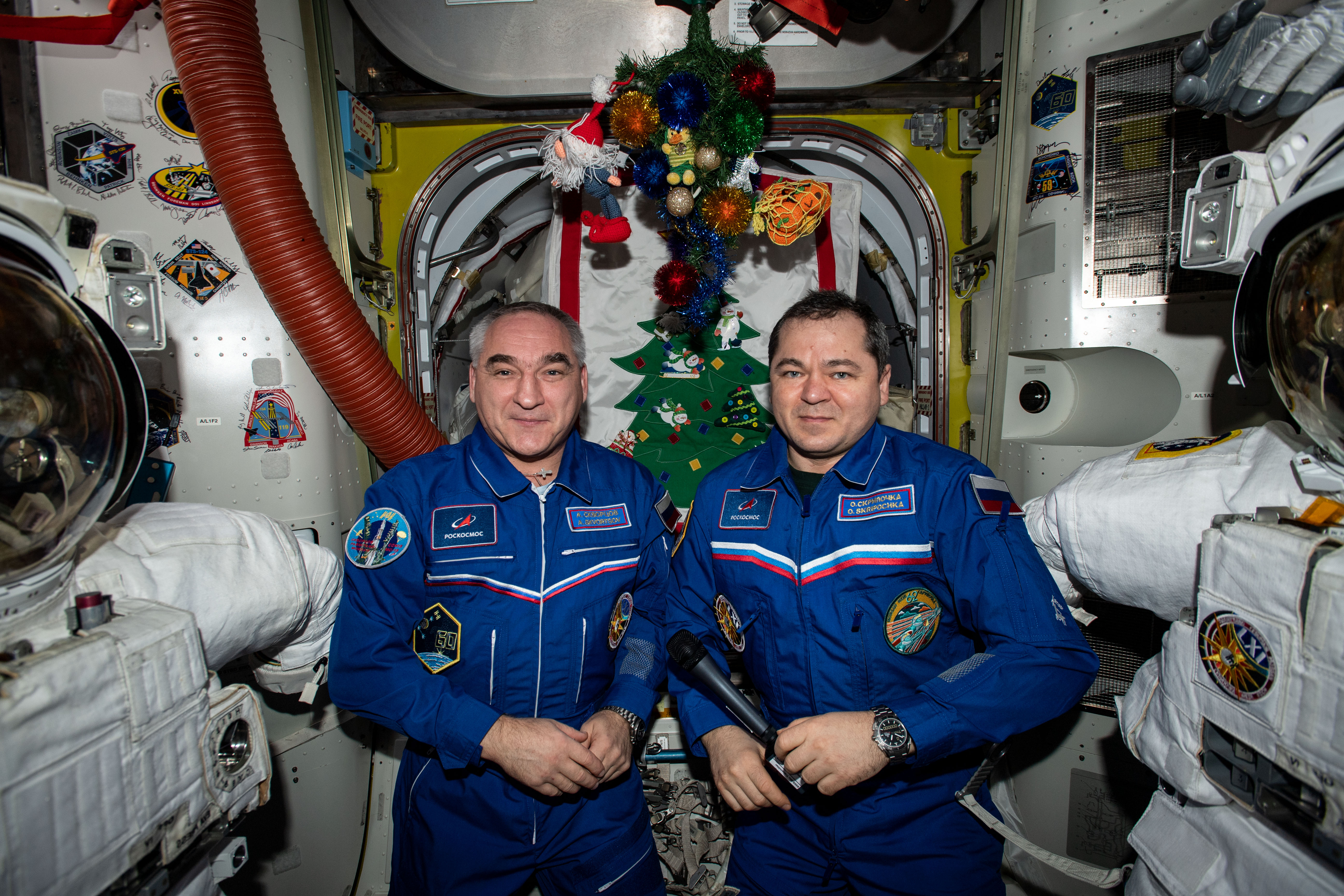 Cosmonauts (from left) Alexander Skvortsov and Oleg Skripochka pose for a portrait during a televised conference with Russian religious leaders during the Orthodox Christian celebration of the Nativity of Christ.