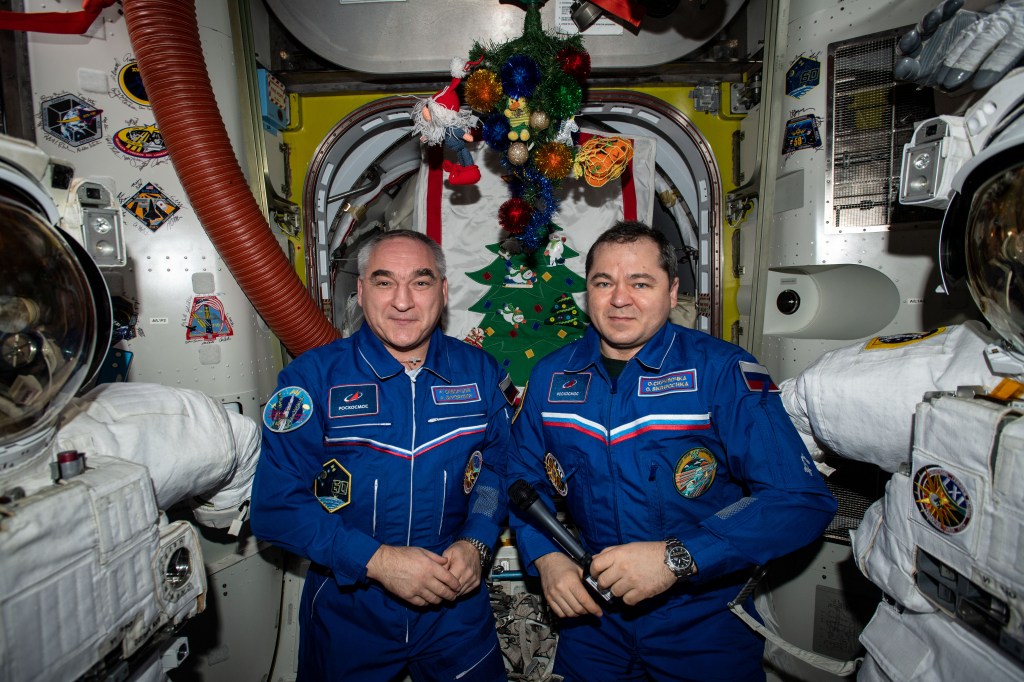 Cosmonauts (from left) Alexander Skvortsov and Oleg Skripochka pose for a portrait during a televised conference with Russian religious leaders during the Orthodox Christian celebration of the Nativity of Christ.